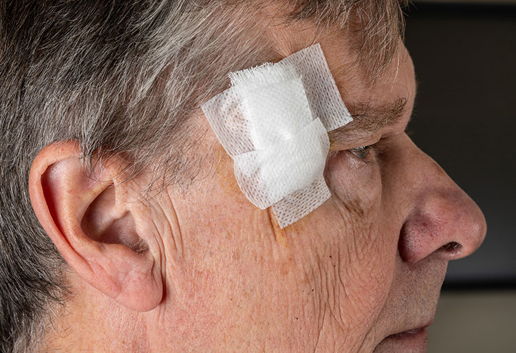 A man with a bandage on his face