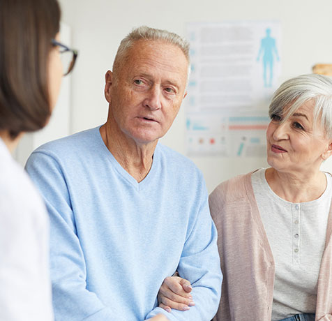 A patient and his wife talking to a doctor