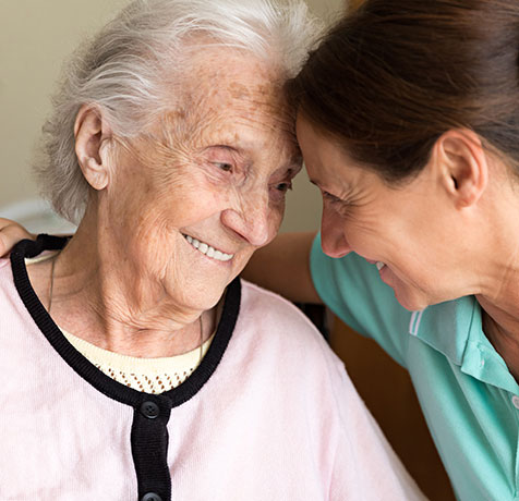 An old woman and her daughter hugging